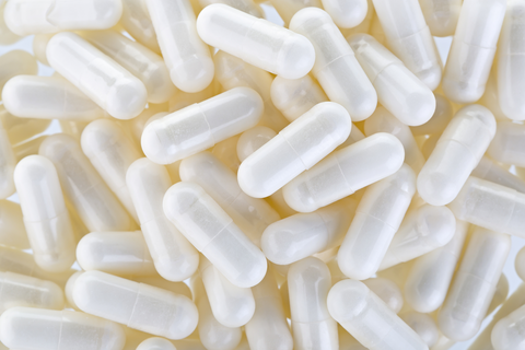 White supplement capsules representing iron bisglycinate supplementation research